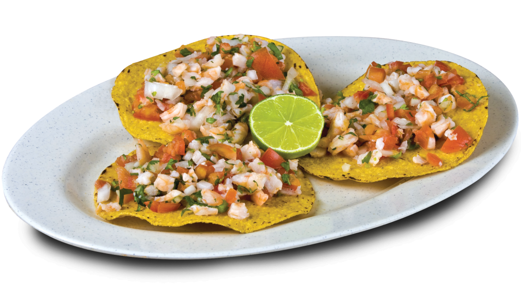 3 ceviche tostadas on a white plate with a slice of lime as garnish