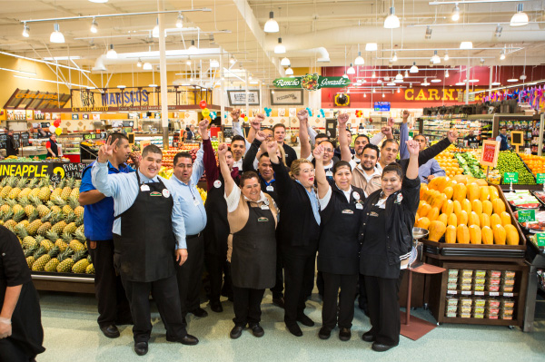 Northgate Employees in a group smiling with fists raised in the air