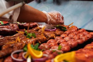 A variety of chorizo being prepared and marinated with vegetables