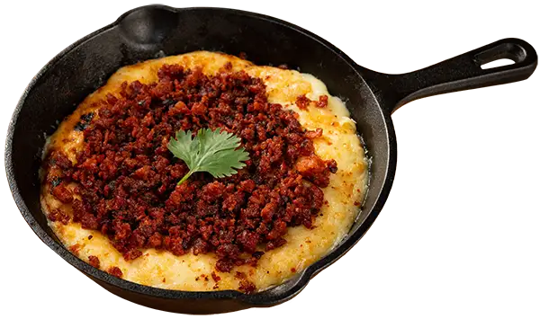 Sizzling melted cheese and crumbled chorizo in a skillet