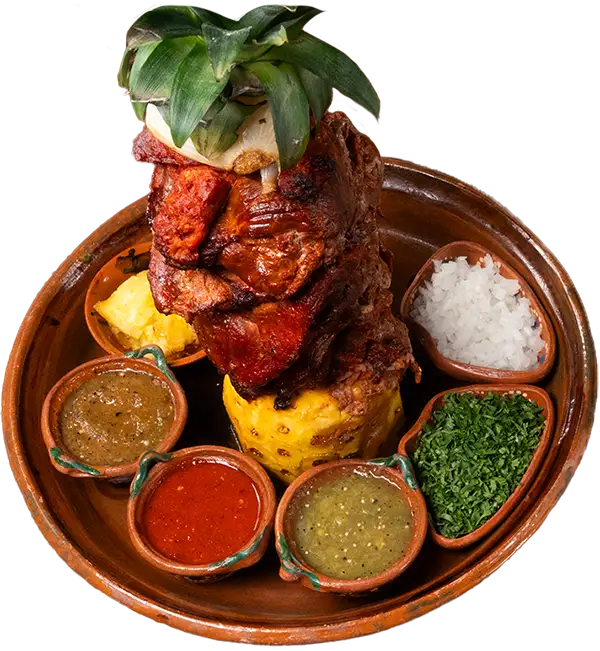 Grilled chorizo and ranchera de res stacked vertically, surrounded by colorful salsas, chopped onions, and cilantro